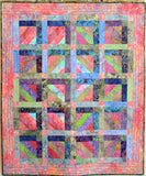 Original strip pieced quilt in pink, green, blue and purple.